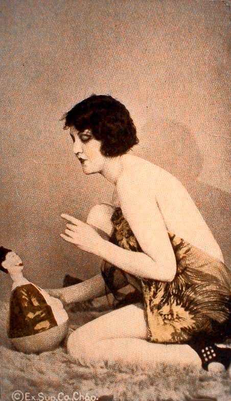 arcade-card-exhibit-supply-company-pin-up-woman-kneeling-profile-in-bare-backed-wrap-reproving-doll-1920s