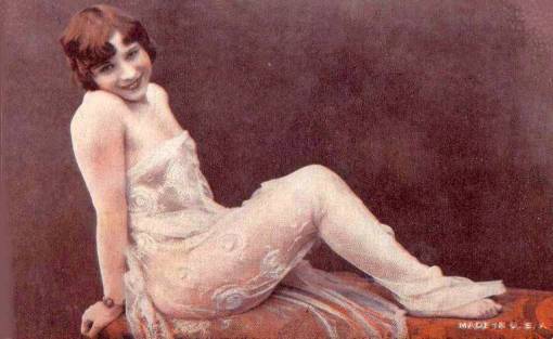 arcade-card-unknown-company-style-resembles-exhibit-supply-woman-in-lace-reclining-on-a-bench-with-bobbed-hair-1920s