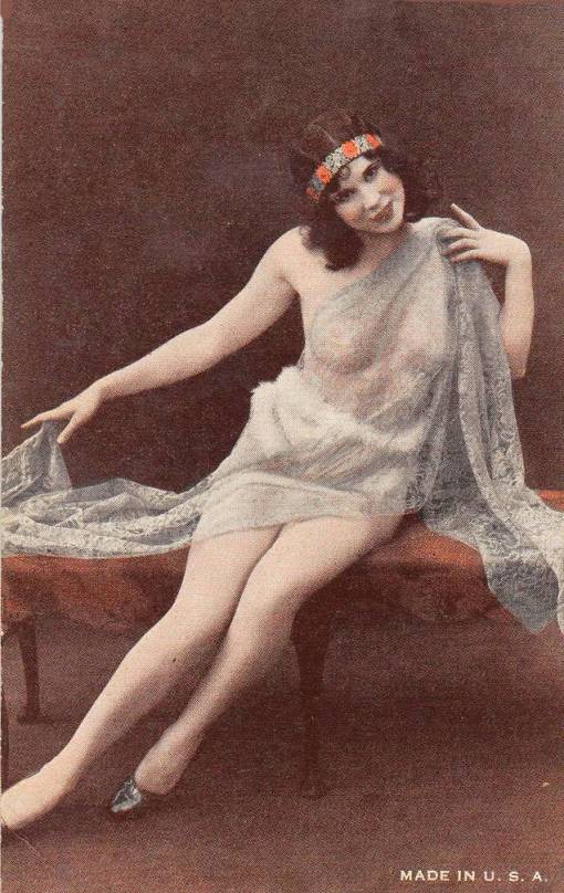 arcade-card-unknown-publisher-style-coulb-exhibit-supply-pin-up-woman-on-bench-with-veil-and-handband-and-graceful-hands-1920s