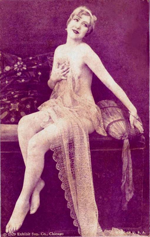 arcade-card-exhibit-supply-company-pin-up-woman-on-sofa-holding-long-lace-over-her-the-pose-resembles-an-old-master-1929
