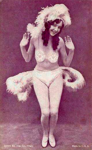 arcade-card-exhibit-supply-company-pin-up-woman-in-feathery-exotic-two-piece-outfit-with-hands-up-looking-into-camera-1926