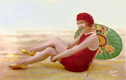 arcade-card-french-woman-in-bathing-suit-and-cap-with-parasol-sitting-on-beach-set-1920s