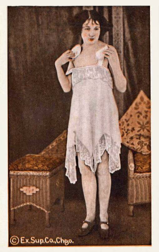 ARCADE CARD - EXHIBIT SUPPLY COMPANY - PIN UP - SWEET-FACED WOMAN IN NIGHTIE STANDING AND POWDERING HERSELF - TINTED - 1920s