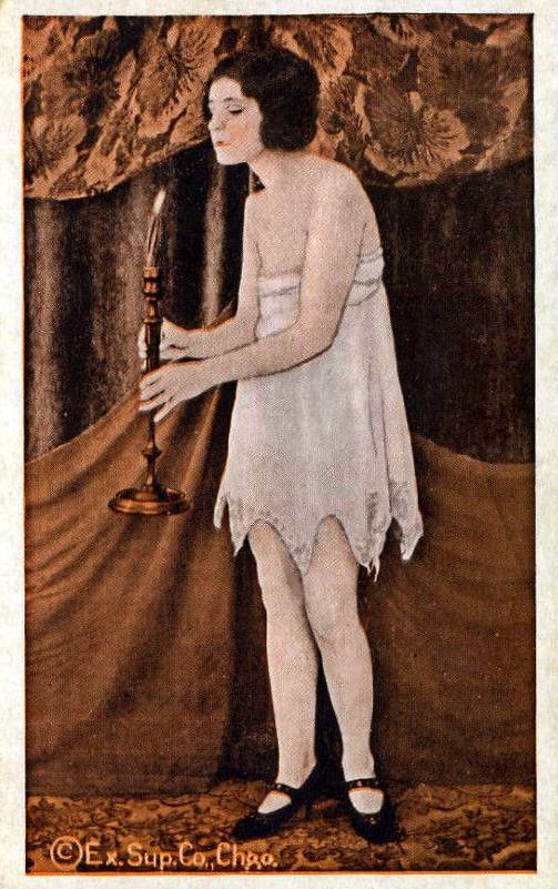 ARCADE CARD - EXHIBIT SUPPLY COMPANY - PIN UP - WOMAN IN NIGHTIE CARRYING A TALL CANDLESTICK IN FRONT OF HER - TINTED - 1920s